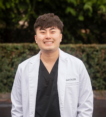 Dr. Samuel Cho and family practitioners consulting in a dental operatory